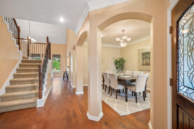 4726 Ashley Hope Dr, Katy, TX 77494 - foyer entrance with a chandelier, arched walkways, stairway, ornamental molding, and dark wood finished floors