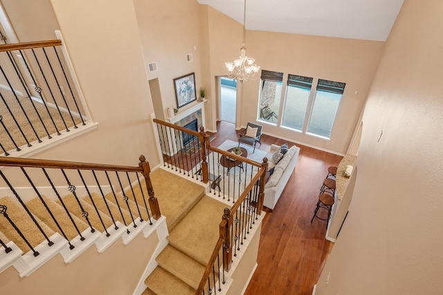 4726 Ashley Hope Dr, Katy, TX 77494 - stairway with high vaulted ceiling, wood finished floors, a chandelier, and baseboards