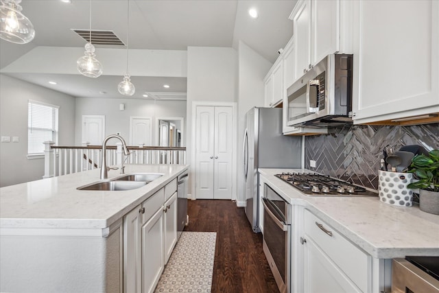 2020 Millbridge Spring Ln, Houston, TX 77051 - kitchen with appliances with stainless steel finishes, a sink, decorative backsplash, dark wood-style flooring, and white cabinetry