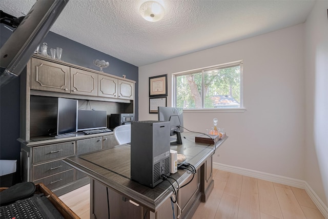 2831 Thorne Creek Ln, Houston, TX 77073 - office featuring a textured ceiling, light wood-type flooring, and baseboards
