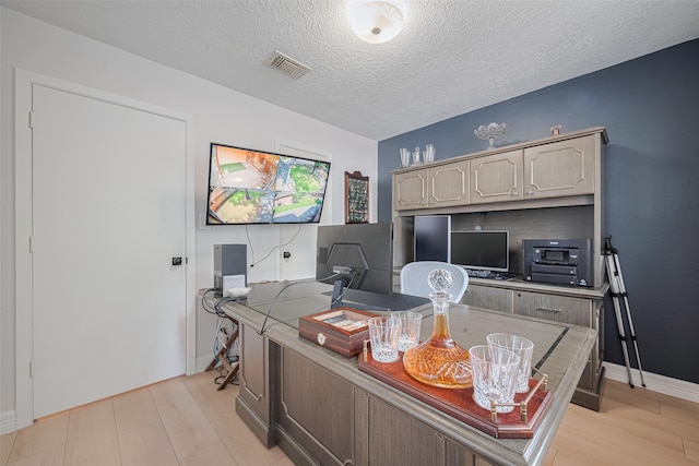 2831 Thorne Creek Ln, Houston, TX 77073 - home office with light wood-type flooring, a textured ceiling, and baseboards