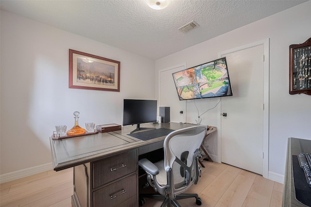 2831 Thorne Creek Ln, Houston, TX 77073 - office with light wood finished floors, a textured ceiling, and baseboards