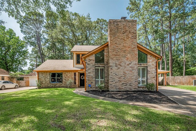 2831 Thorne Creek Ln, Houston, TX 77073 - view of front of home with driveway, a chimney, stone siding, and brick siding