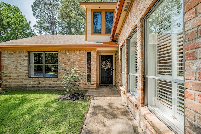2831 Thorne Creek Ln, Houston, TX 77073 - doorway to property featuring brick siding, roof with shingles, and a yard