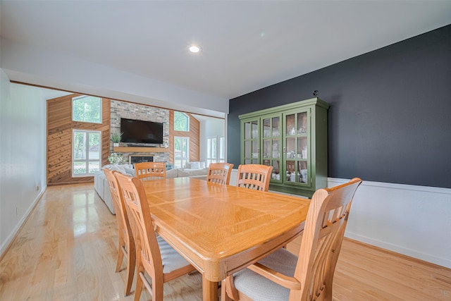 2831 Thorne Creek Ln, Houston, TX 77073 - dining area with light wood-style flooring, a fireplace, and baseboards