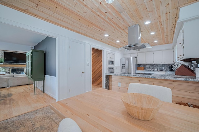 2831 Thorne Creek Ln, Houston, TX 77073 - kitchen featuring appliances with stainless steel finishes, island range hood, white cabinets, wooden ceiling, and recessed lighting