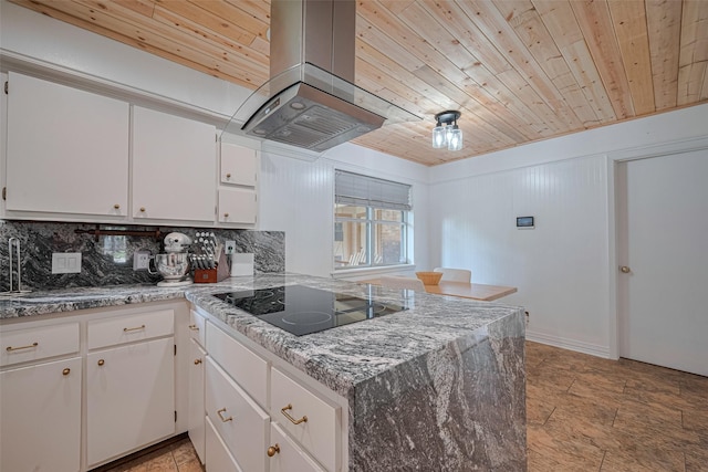 2831 Thorne Creek Ln, Houston, TX 77073 - kitchen with island range hood, black electric stovetop, wood ceiling, white cabinets, and backsplash