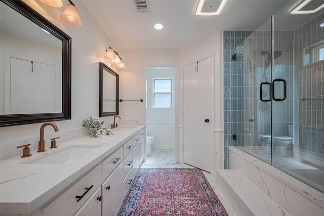 2831 Thorne Creek Ln, Houston, TX 77073 - bathroom featuring toilet, double vanity, marble look tile flooring, a shower stall, and healthy amount of natural light