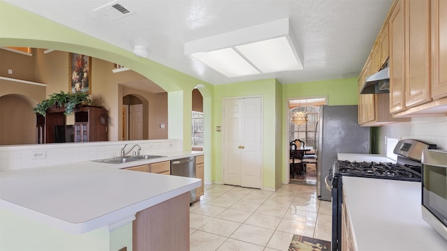 12422 Glenleigh Dr, Houston, TX 77014 - kitchen featuring a sink, appliances with stainless steel finishes, light countertops, under cabinet range hood, and light tile patterned floors