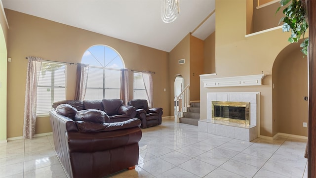12422 Glenleigh Dr, Houston, TX 77014 - living room with arched walkways, high vaulted ceiling, baseboards, and plenty of natural light