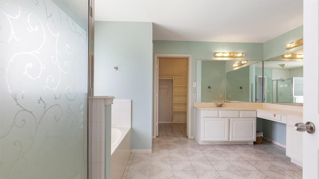 12422 Glenleigh Dr, Houston, TX 77014 - full bath featuring a bath, vanity, a stall shower, a spacious closet, and baseboards