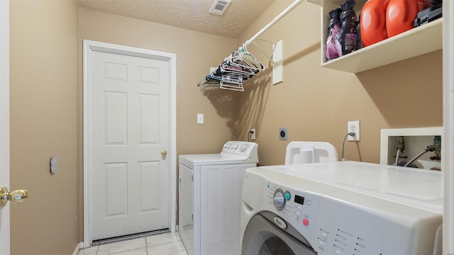 12422 Glenleigh Dr, Houston, TX 77014 - laundry room featuring independent washer and dryer, a textured ceiling, and baseboards