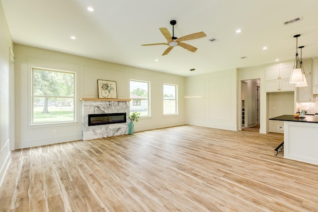 5206 4th St, Danbury, TX 77534 - unfurnished living room with a premium fireplace, a ceiling fan, light wood-style flooring, recessed lighting, and baseboards