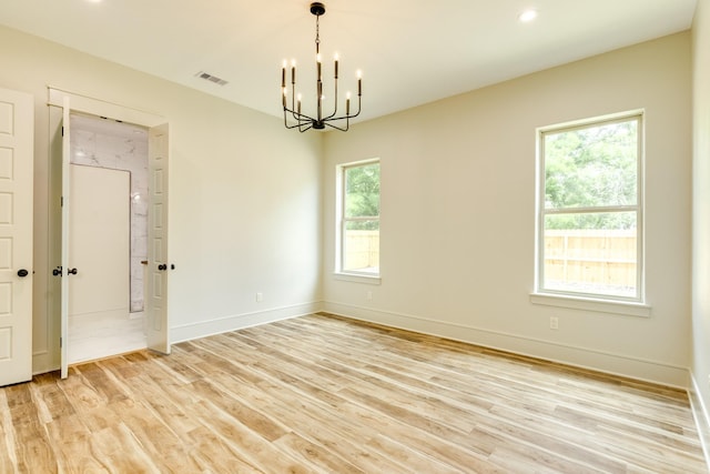 5206 4th St, Danbury, TX 77534 - empty room featuring a chandelier, light wood-style flooring, baseboards, and recessed lighting