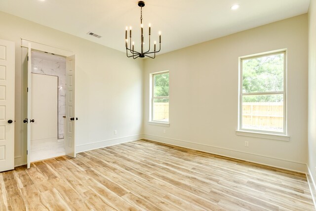 5206 4th St, Danbury, TX 77534 - empty room with a chandelier, light wood finished floors, baseboards, and recessed lighting