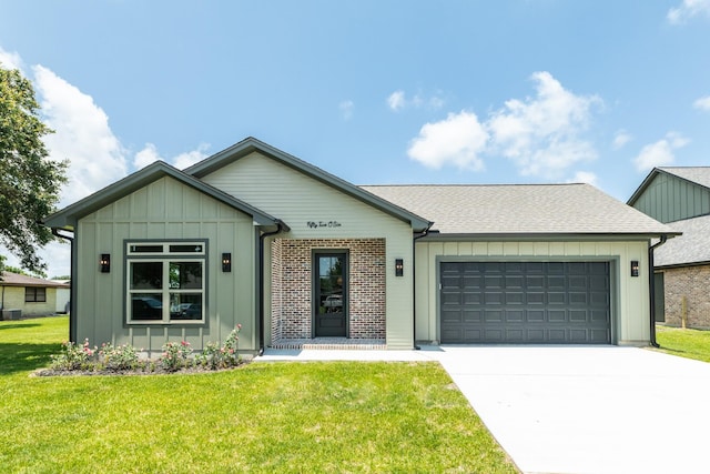 5206 4th St, Danbury, TX 77534 - view of front of property with an attached garage, concrete driveway, a front yard, and board and batten siding