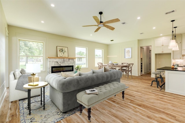 5206 4th St, Danbury, TX 77534 - living room with plenty of natural light, a fireplace, light wood finished floors, ceiling fan, and recessed lighting