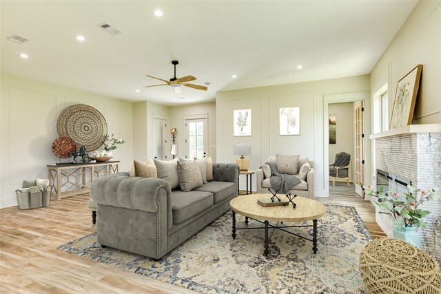 5206 4th St, Danbury, TX 77534 - living room with wood finished floors, recessed lighting, a glass covered fireplace, and a ceiling fan