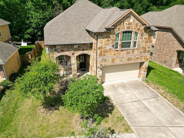 6707 Hunters Creek Ln, Baytown, TX 77521 - french country style house with stone siding, driveway, a garage, and roof with shingles
