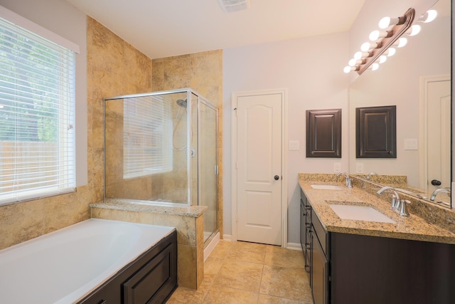 6707 Hunters Creek Ln, Baytown, TX 77521 - bathroom with a garden tub, double vanity, a stall shower, baseboards, and tile patterned floors