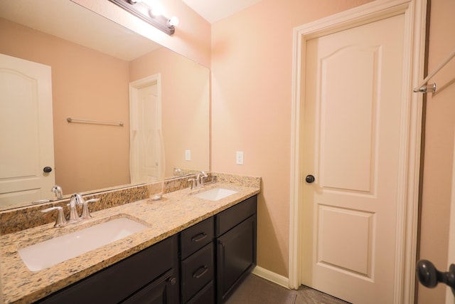6707 Hunters Creek Ln, Baytown, TX 77521 - bathroom featuring double vanity and baseboards