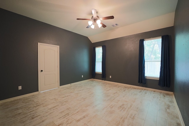 6707 Hunters Creek Ln, Baytown, TX 77521 - unfurnished room with a ceiling fan, wood finished floors, vaulted ceiling, a textured wall, and baseboards