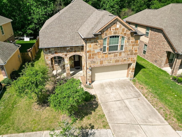 6707 Hunters Creek Ln, Baytown, TX 77521 - french provincial home with stone siding, driveway, an attached garage, and roof with shingles