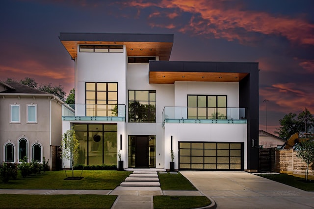 2037 Norfolk St, Houston, TX 77098 - contemporary home with a balcony, stucco siding, concrete driveway, and a garage