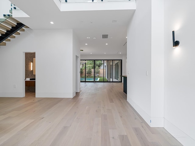 2037 Norfolk St, Houston, TX 77098 - unfurnished living room with light wood-style floors, recessed lighting, stairs, and baseboards