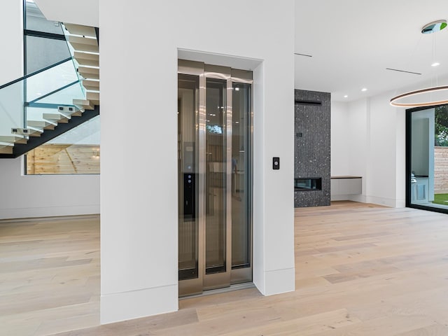 2037 Norfolk St, Houston, TX 77098 - corridor with stairs, wood finished floors, recessed lighting, elevator, and baseboards