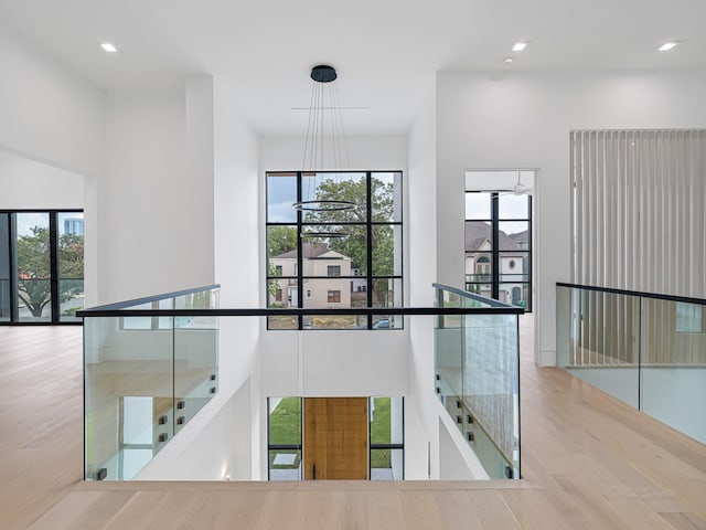 2037 Norfolk St, Houston, TX 77098 - corridor with an upstairs landing, wood finished floors, and recessed lighting