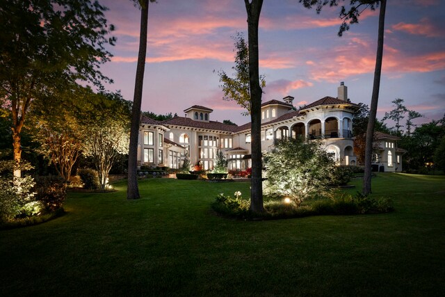 18 S Gary Glen Cir, The Woodlands, TX 77382 - back of property at dusk featuring a chimney and a lawn