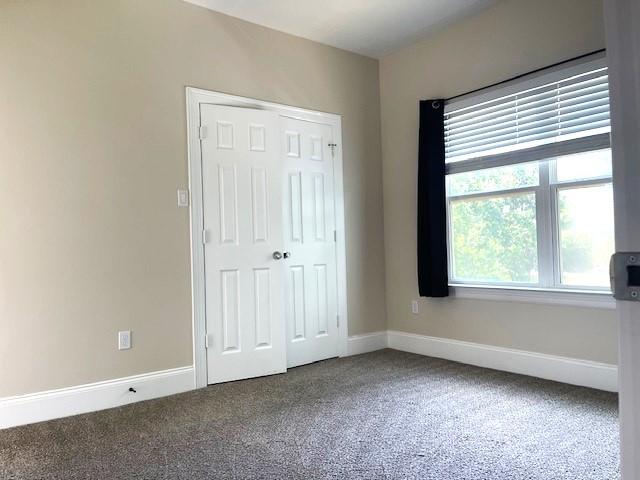 9310 Coffee St, Houston, TX 77033 - unfurnished bedroom featuring carpet, baseboards, and a closet