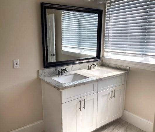 9310 Coffee St, Houston, TX 77033 - full bath featuring baseboards, double vanity, and plenty of natural light