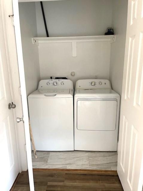 9310 Coffee St, Houston, TX 77033 - washroom with separate washer and dryer and wood finished floors