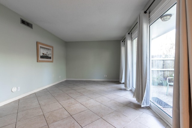 1726 Broadway Unit 19, Galveston, TX 77550 - empty room with light tile patterned floors and baseboards