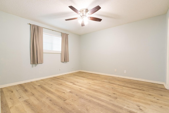 1726 Broadway Unit 19, Galveston, TX 77550 - spare room with light wood-style flooring, ceiling fan, baseboards, and a textured ceiling