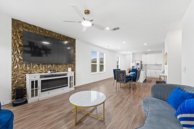 21123 Coral Blossom Ln, Cypress, TX 77433 - living area with wood finished floors, ceiling fan, recessed lighting, and baseboards