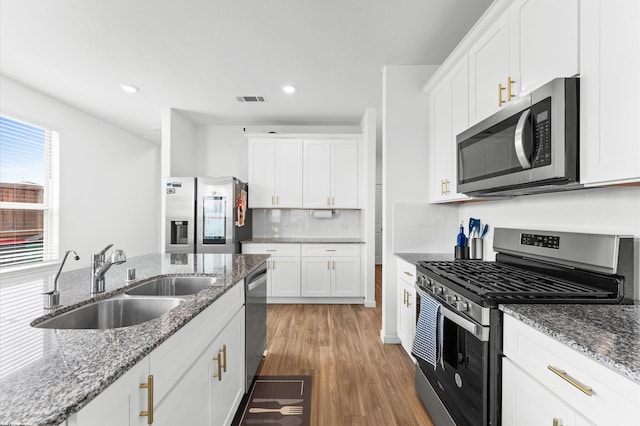 21123 Coral Blossom Ln, Cypress, TX 77433 - kitchen featuring appliances with stainless steel finishes, a sink, white cabinetry, light wood finished floors, and recessed lighting