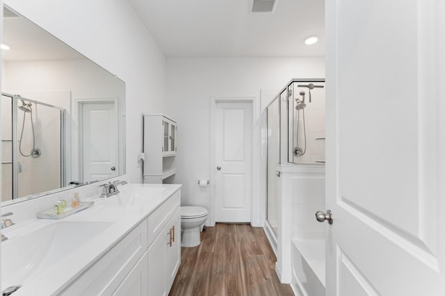21123 Coral Blossom Ln, Cypress, TX 77433 - full bathroom with a shower stall, double vanity, toilet, wood finished floors, and recessed lighting