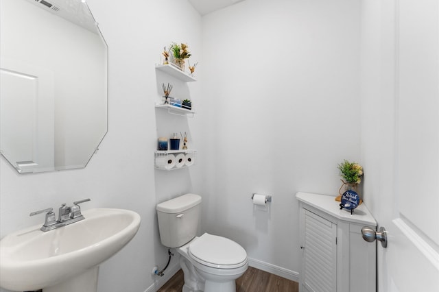 21123 Coral Blossom Ln, Cypress, TX 77433 - half bath featuring a sink, wood finished floors, toilet, and baseboards