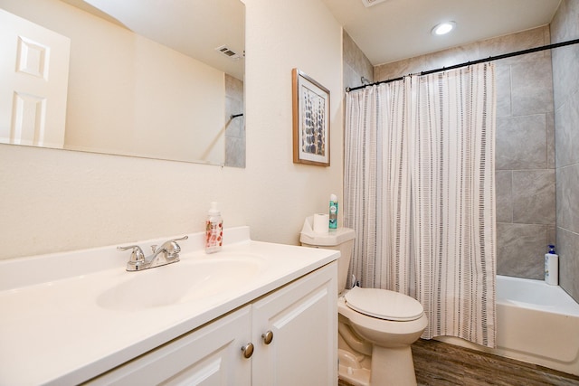 15115 Monrad Dr, Houston, TX 77053 - full bath featuring wood finished floors, toilet, vanity, and shower / bath combination with curtain