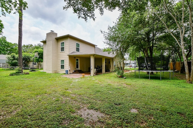 15115 Monrad Dr, Houston, TX 77053 - back of property featuring a patio, a chimney, and a trampoline