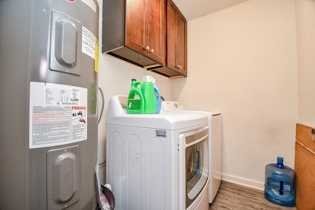 15115 Monrad Dr, Houston, TX 77053 - laundry room featuring electric water heater, washer and dryer, cabinet space, baseboards, and light wood finished floors
