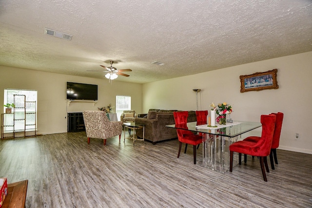 15115 Monrad Dr, Houston, TX 77053 - dining area with wood finished floors, a textured ceiling, ceiling fan, and baseboards