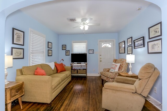 1523 22nd St, Galveston, TX 77550 - living room with arched walkways, a ceiling fan, and dark wood-type flooring