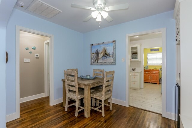 1523 22nd St, Galveston, TX 77550 - dining area featuring wood finished floors, ceiling fan, and baseboards