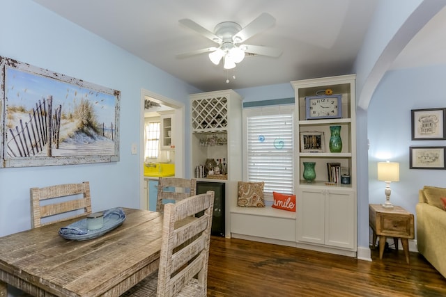 1523 22nd St, Galveston, TX 77550 - dining room featuring wood finished floors, a ceiling fan, and arched walkways