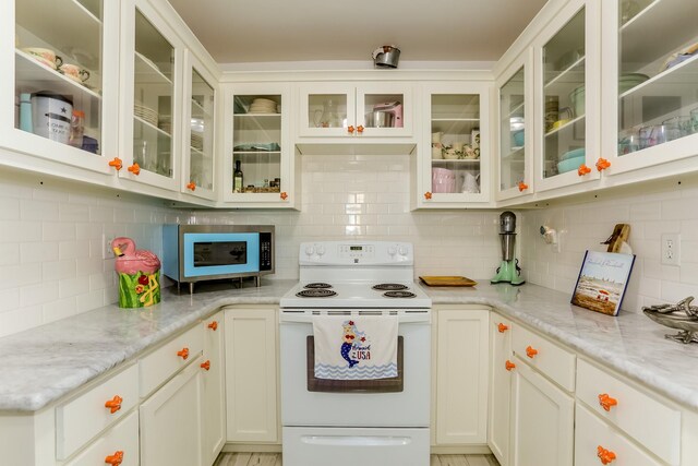 1523 22nd St, Galveston, TX 77550 - kitchen featuring white appliances, tasteful backsplash, light stone countertops, and glass insert cabinets