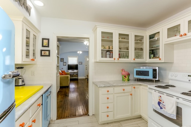 1523 22nd St, Galveston, TX 77550 - kitchen with white appliances, decorative backsplash, white cabinetry, and glass insert cabinets